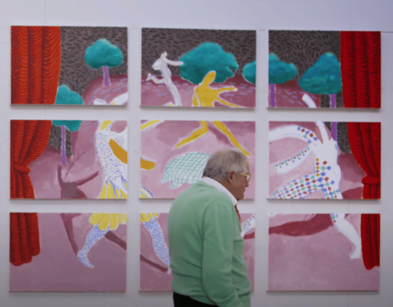 Older gentleman walking past a canvas wall in a museum