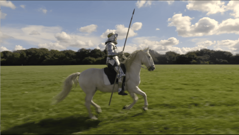 Knight riding a white horse across a field to advertise Jeep