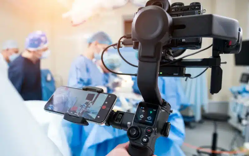 The videographer shoots the surgeon and assistants in the operating room with surgical equipment